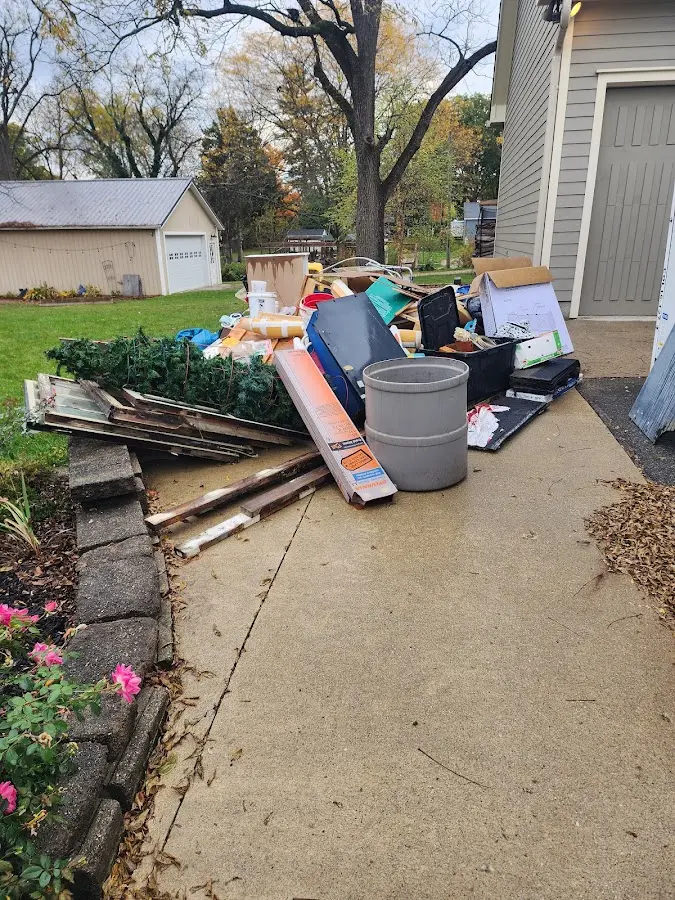 Dumpster being loaded with debris for Roofing Dumpster Rental in Spring Lake